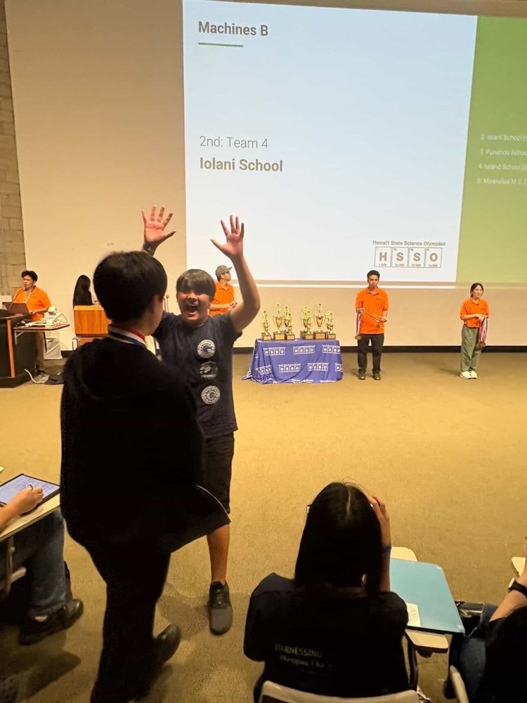 Students celebrating a 2nd place finish at the Hawaiʻi State Science Olympiad with medals and trophies